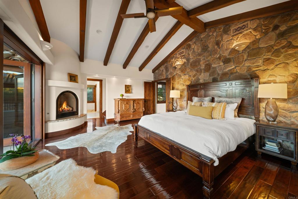 Undisclosed Address Encinitas, CA 92024 - Photo 24 of 30 a spacious bedroom with a bed and a chandelier