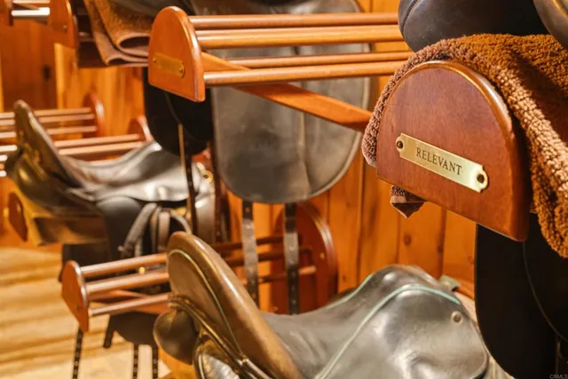 an aerial view of a house with a yard lake and outdoor seating