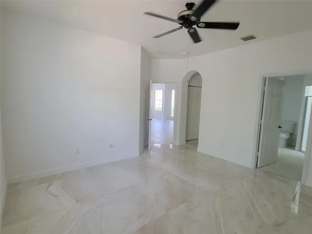 an empty room with closet and windows