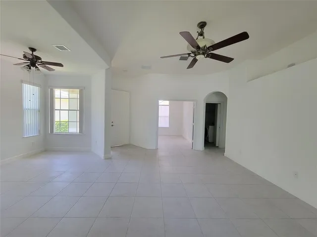 a view of a livingroom with a ceiling fan and window