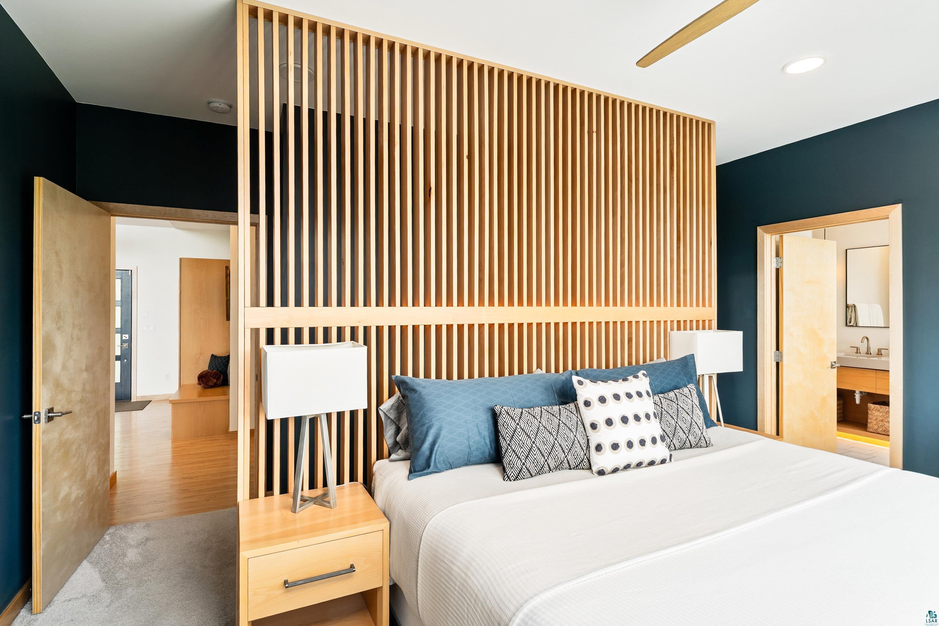 814 Pleasant View Road Duluth, MN 55803 - Photo 20 of 49 Bedroom featuring a natural wood slat partition wall, light wood-finish flooring, a recessed ceiling light, and a contemporary ceiling fan