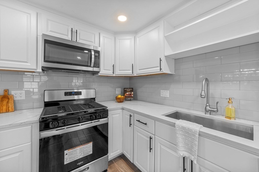 38 Wayside Lane Ashland, MA 01721 - Photo 13 of 40 a kitchen with cabinets stainless steel appliances and a sink
