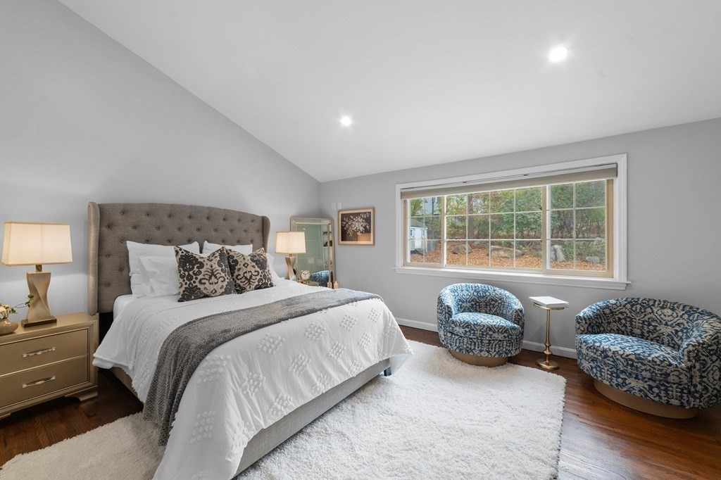38 Wayside Lane Ashland, MA 01721 - Photo 20 of 40 a spacious bedroom with a bed and a couch with wooden floor