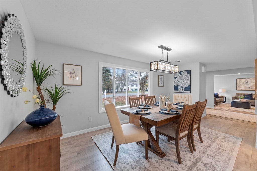 38 Wayside Lane Ashland, MA 01721 - Photo 7 of 40 a view of a dining room with furniture window and wooden floor