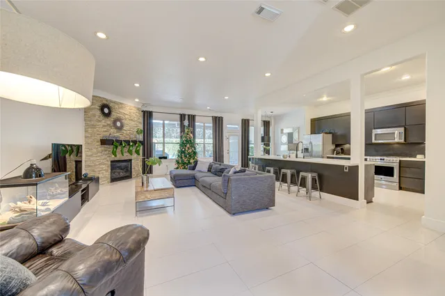 a living room with furniture and a view of kitchen