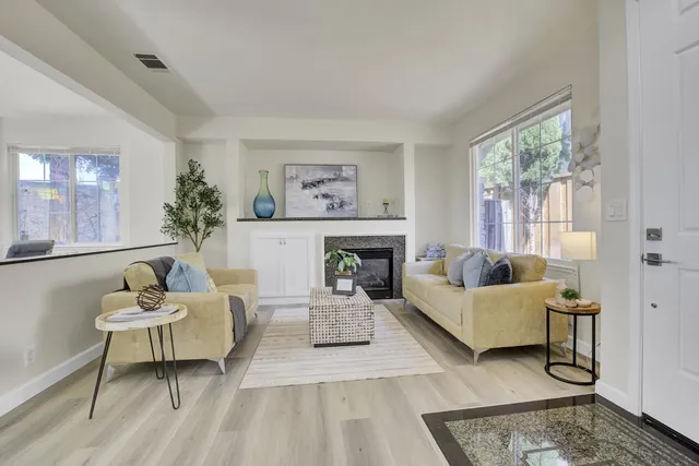 a living room with furniture and a fireplace