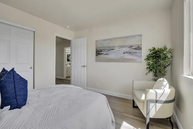 a bedroom with a bed and a potted plant