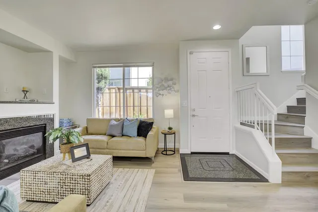 a living room with furniture and a fireplace