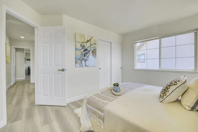 a bedroom with a bed and a window