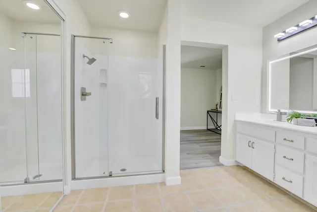 a bathroom with a shower and a sink