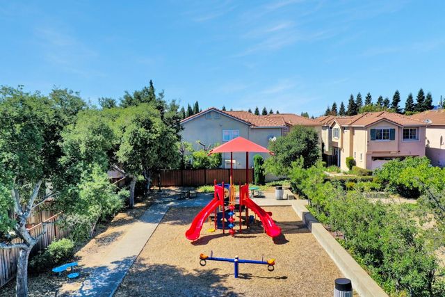 an aerial view of multiple houses with umbrellas