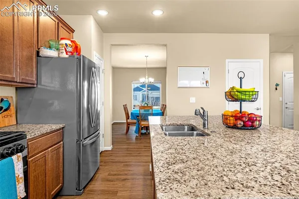 a kitchen with stainless steel appliances granite countertop a refrigerator and a sink