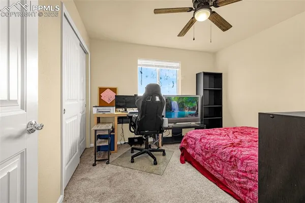 a view of a workspace with furniture and a window