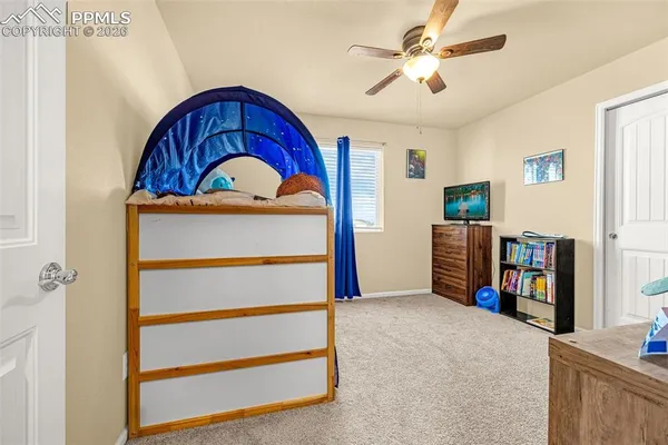 a view of a livingroom with furniture and a ceiling fan