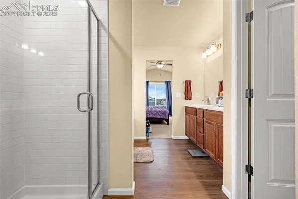 a view of a bathroom with tub shower mirror and window
