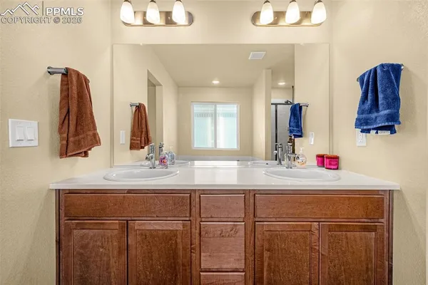 a bathroom with a sink vanity and a mirror