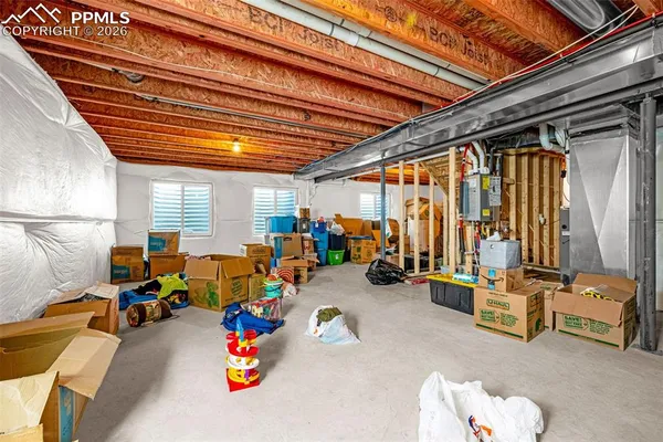 a view of gym equipment with furniture and a ceiling fan