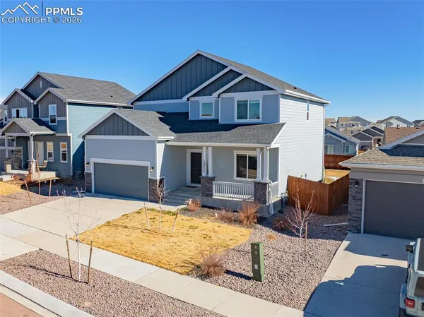 an aerial view of residential houses with city view