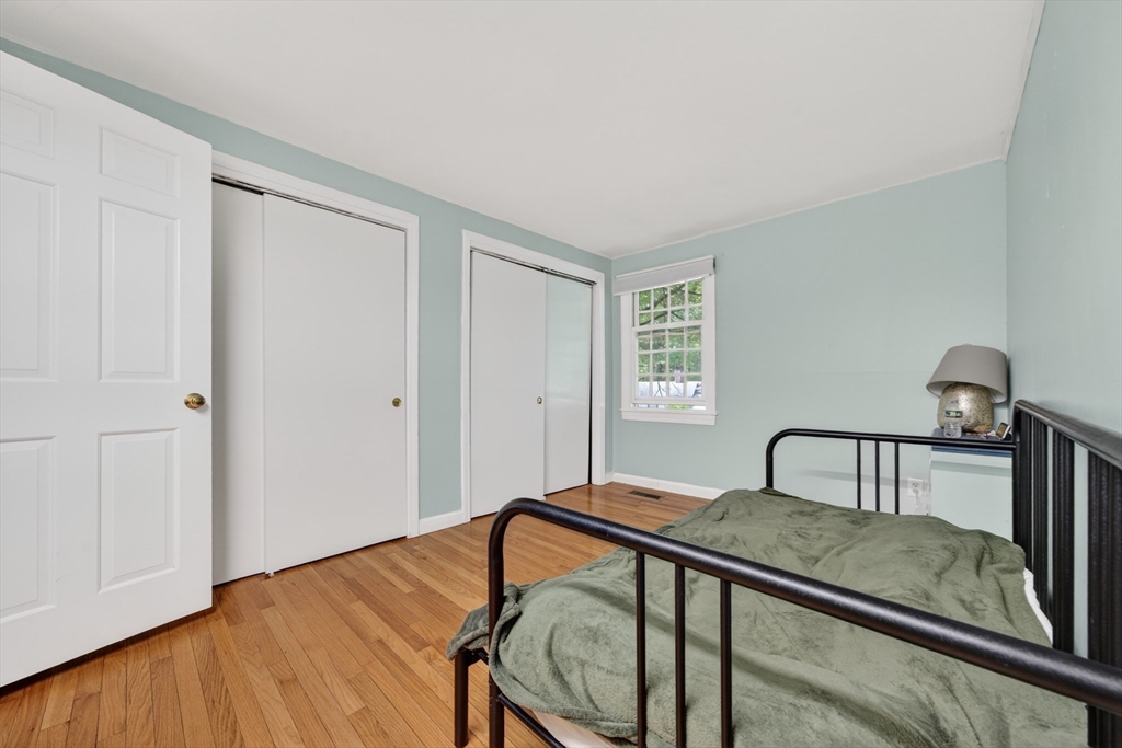 68 Jericho Road, Unit 68 Weston, MA 02493 - Photo 9 of 25 a bedroom with a bed window and wooden floor