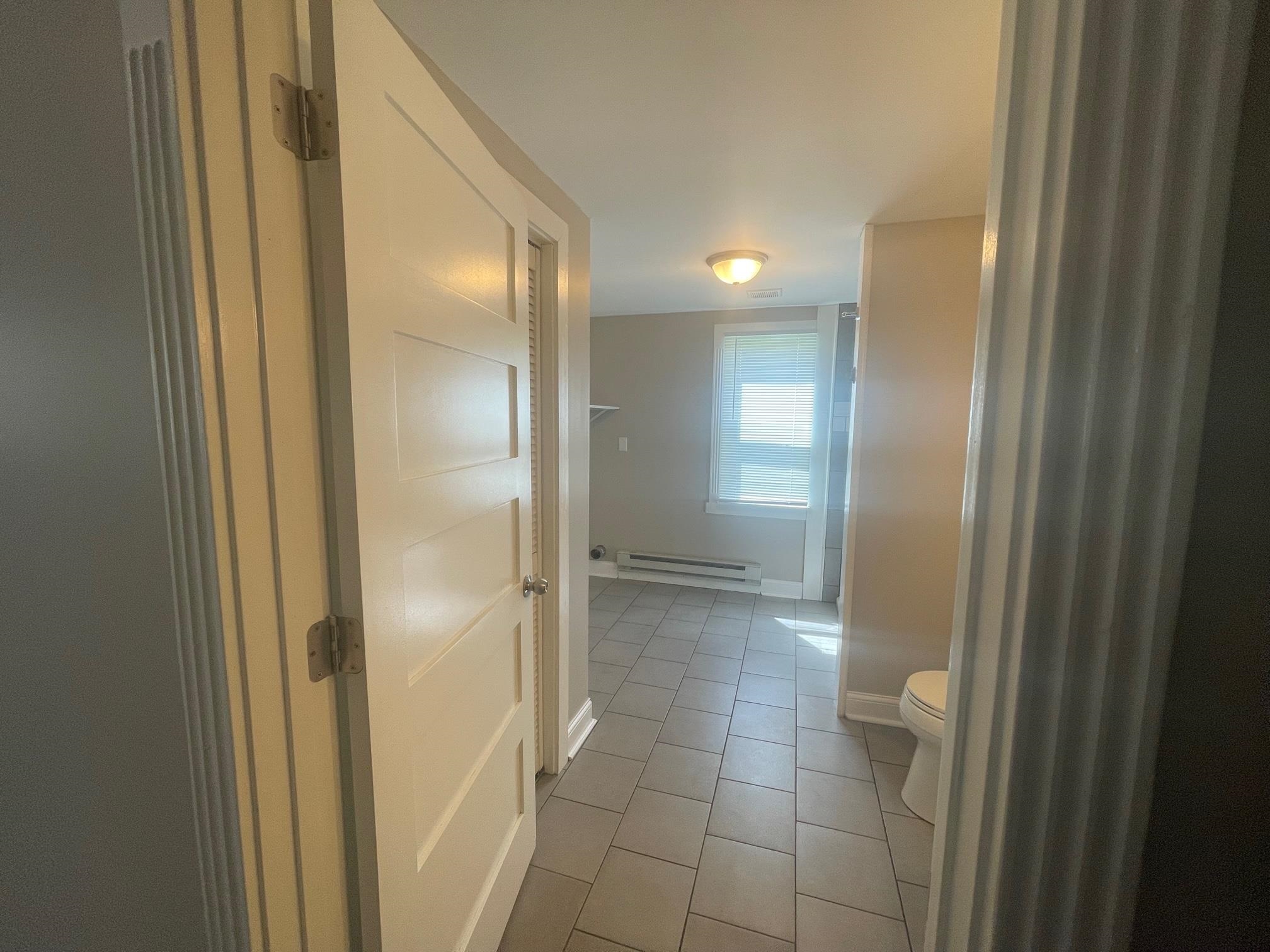 519 Brooke Road Rockford, IL 61109 - Photo 6 of 11 a bathroom with a glass shower door and a mirror