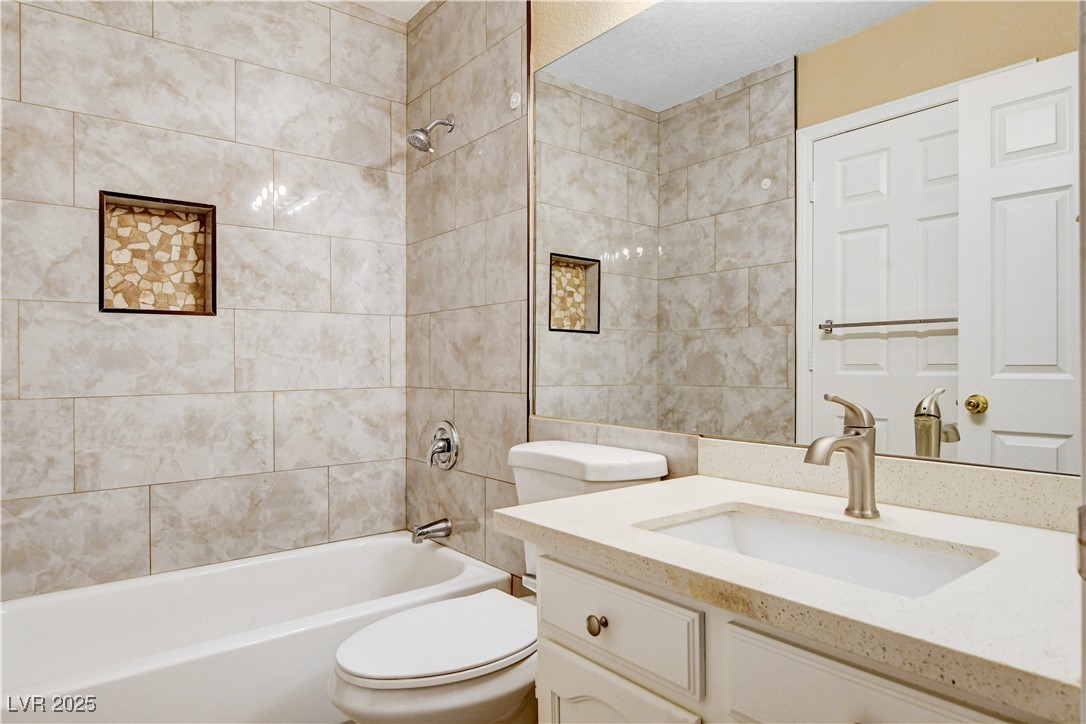 2824 Mayfair Avenue Henderson, NV 89074 - Photo 25 of 46 Full bathroom featuring shower / bathtub combination, vanity, and tile walls