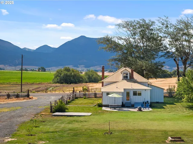 a aerial view of a house with a yard basket ball court and outdoor seating