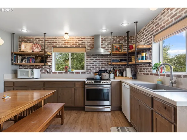 a kitchen with kitchen island a sink stove and cabinets