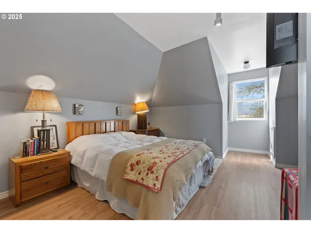 a bedroom with a bed and a lamp on table