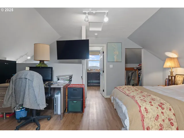 a bedroom with a bed and a flat screen tv