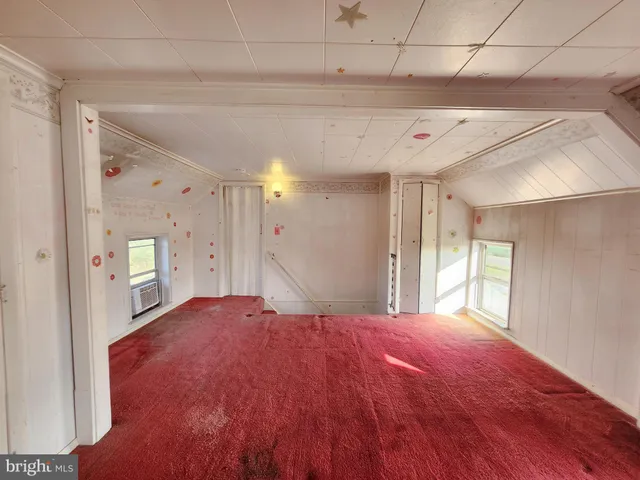 a view of a room with a stylish ceiling fan and entryway