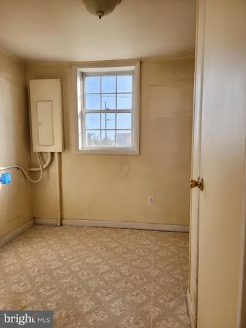 a view of staircase with wooden floor and white walls