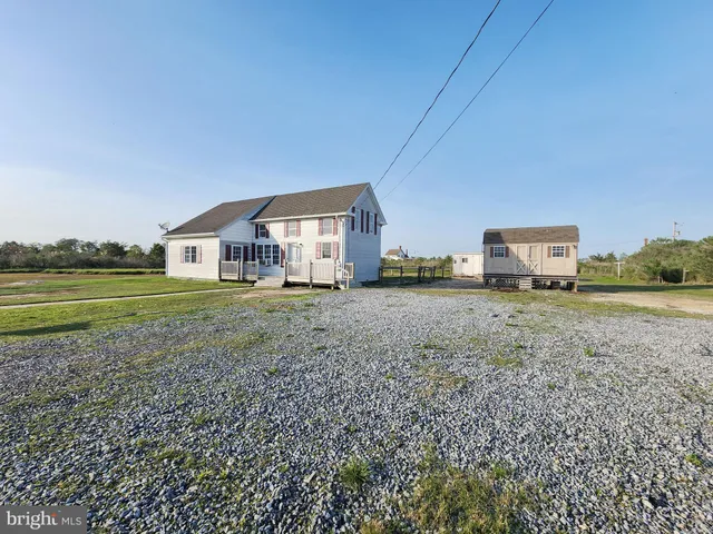 a view of a house with a yard and sitting area