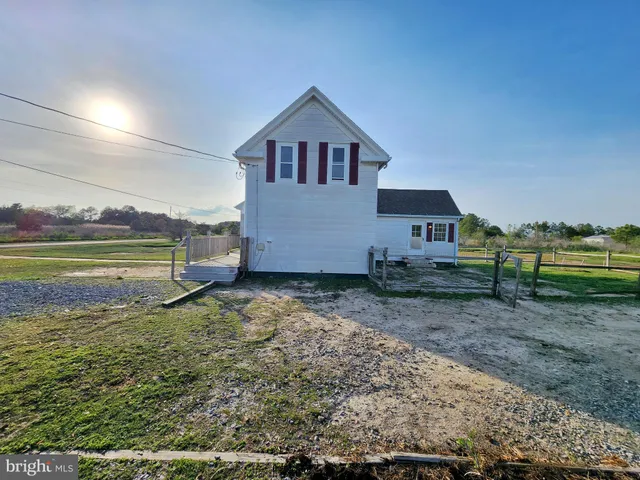 a backyard of a house with a yard and fence