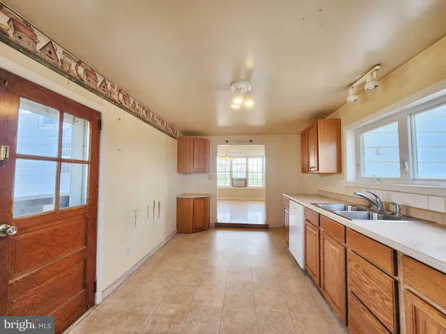 a bathroom with a tub a sink a mirror and a shower