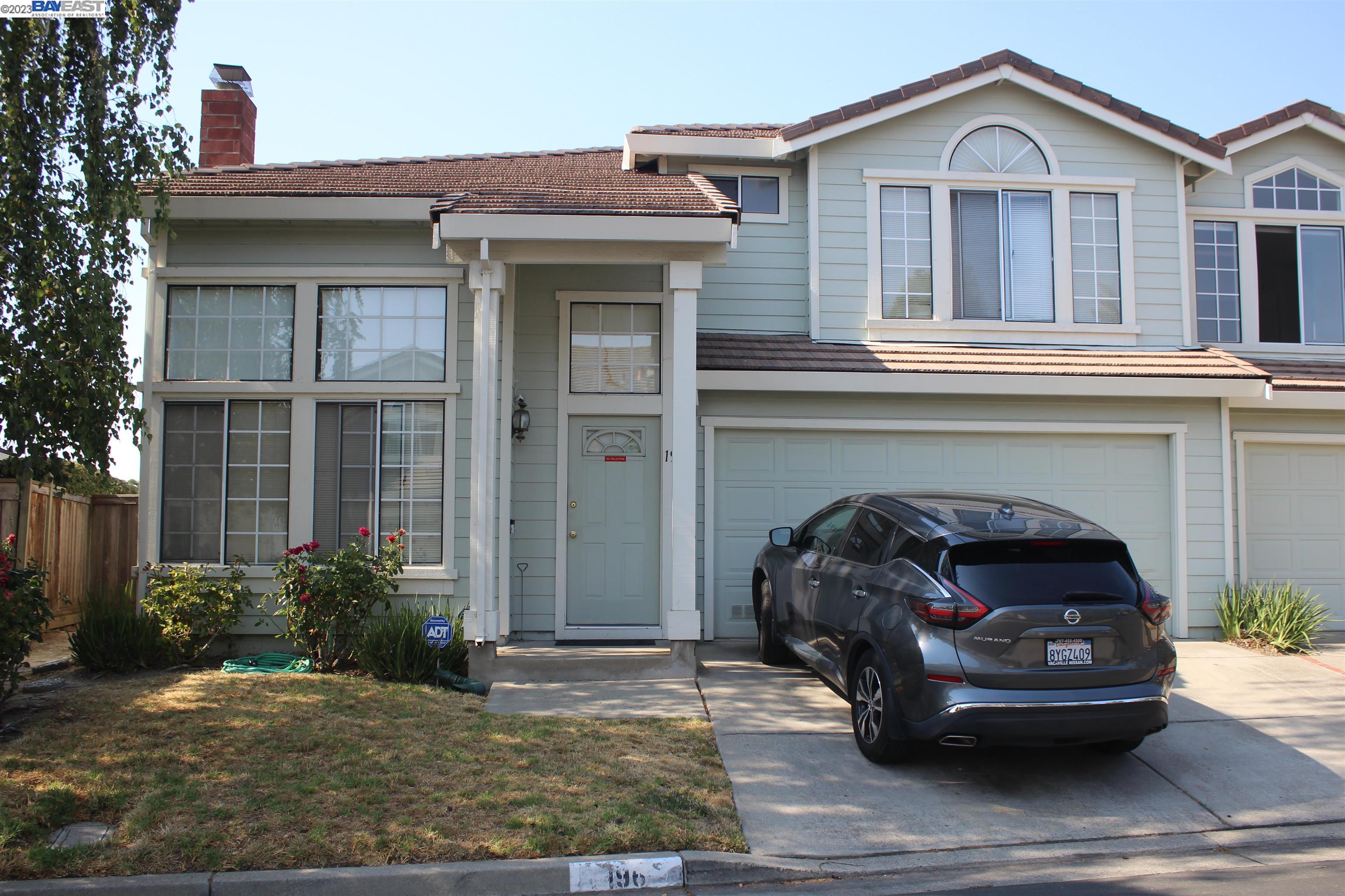 a view of a car parked front of a house