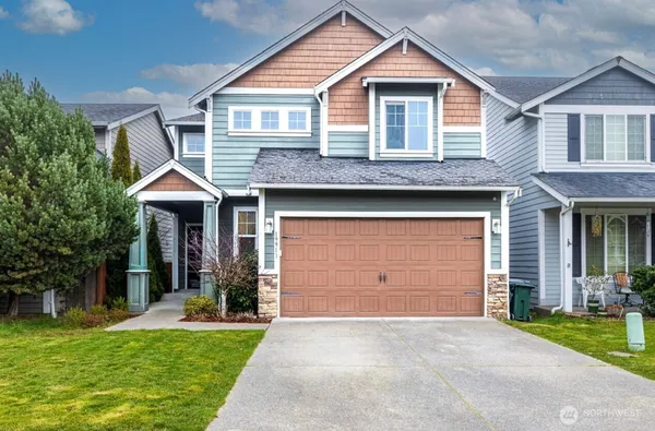 a front view of a house with a yard and garage