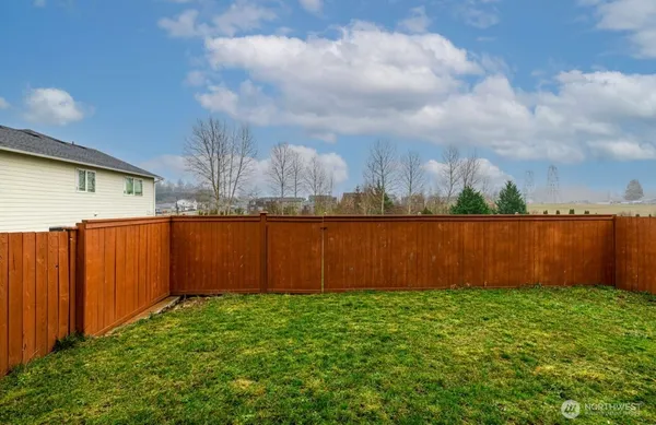 a view of a backyard with brick wall