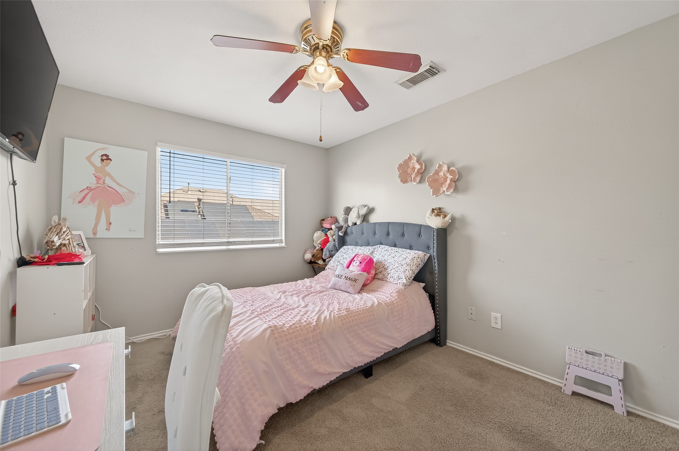 2202 Falling Oaks Road Houston, TX 77038 - Photo 31 of 47 a bedroom with a bed and a chandelier