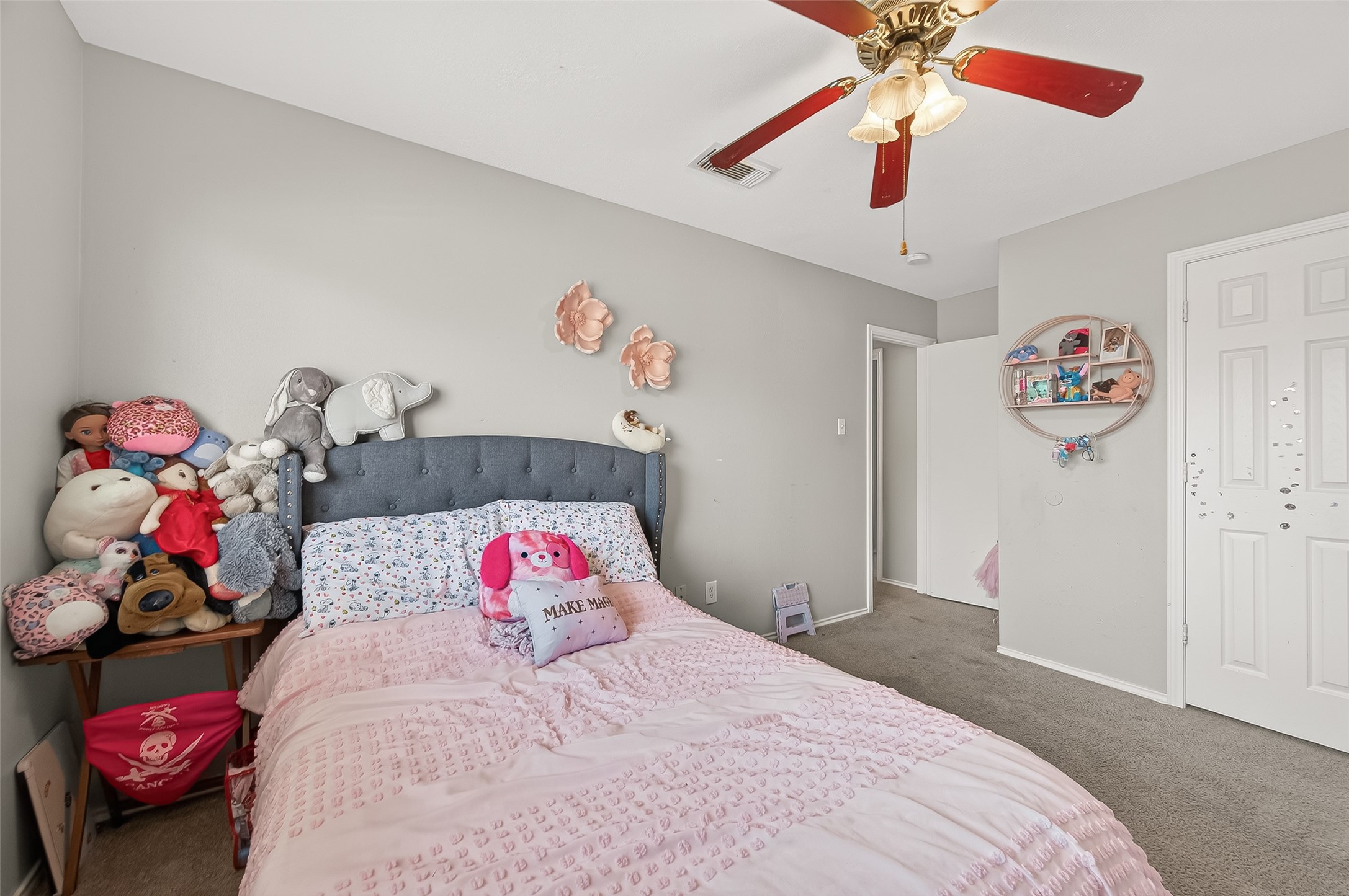 2202 Falling Oaks Road Houston, TX 77038 - Photo 32 of 47 a bedroom with a bed and a chandelier