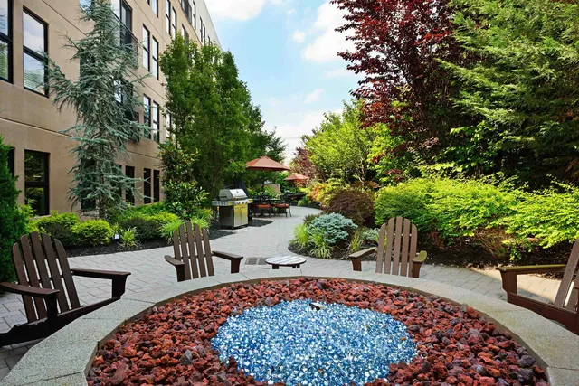 a view of patio with chairs and table under an umbrella