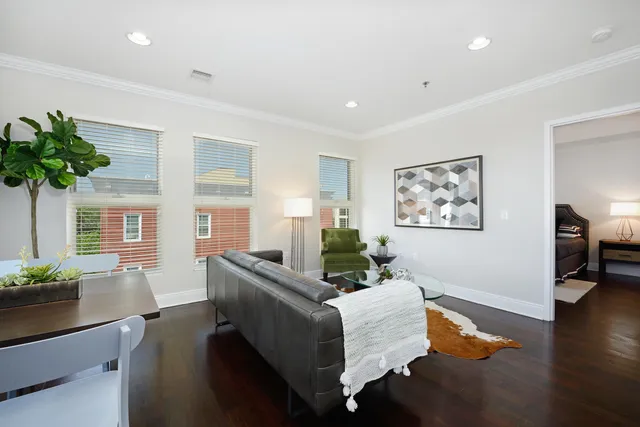 a living room with furniture and wooden floor