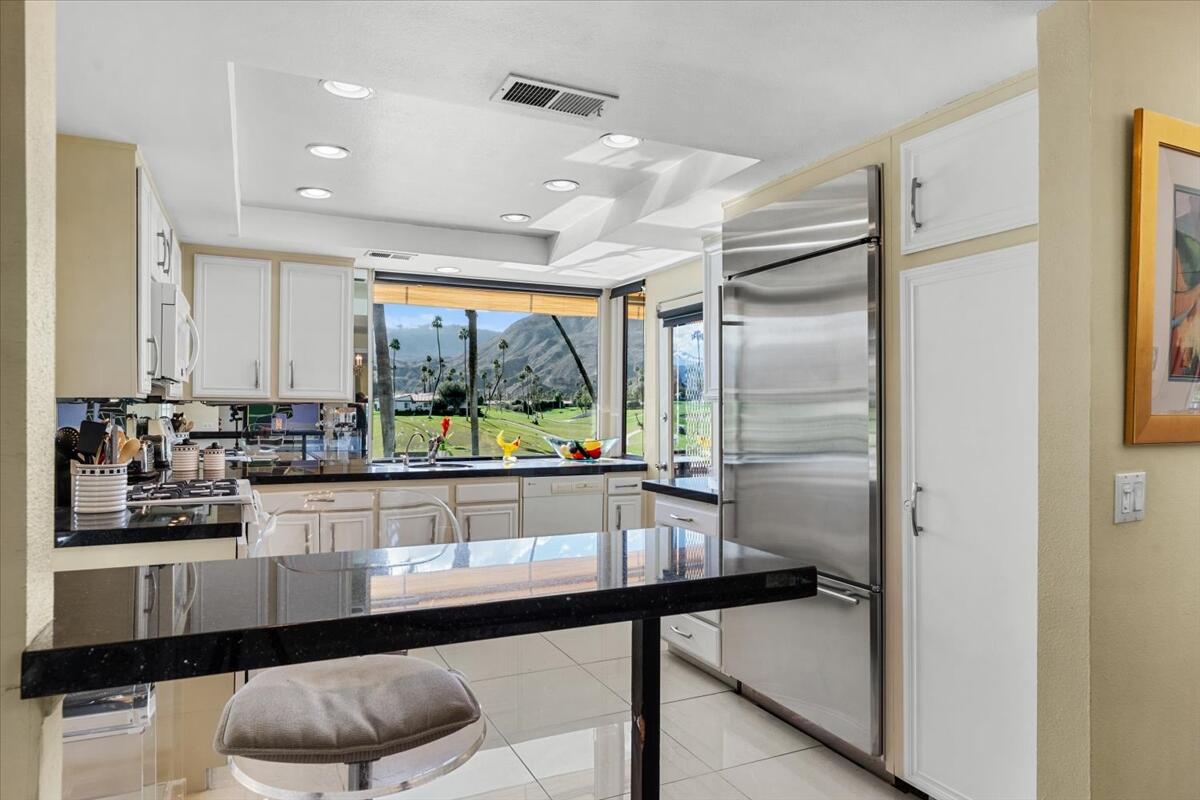 1 Cueta Drive Rancho Mirage, CA 92270 - Photo 11 of 39 a kitchen with stainless steel appliances granite countertop a refrigerator and a sink