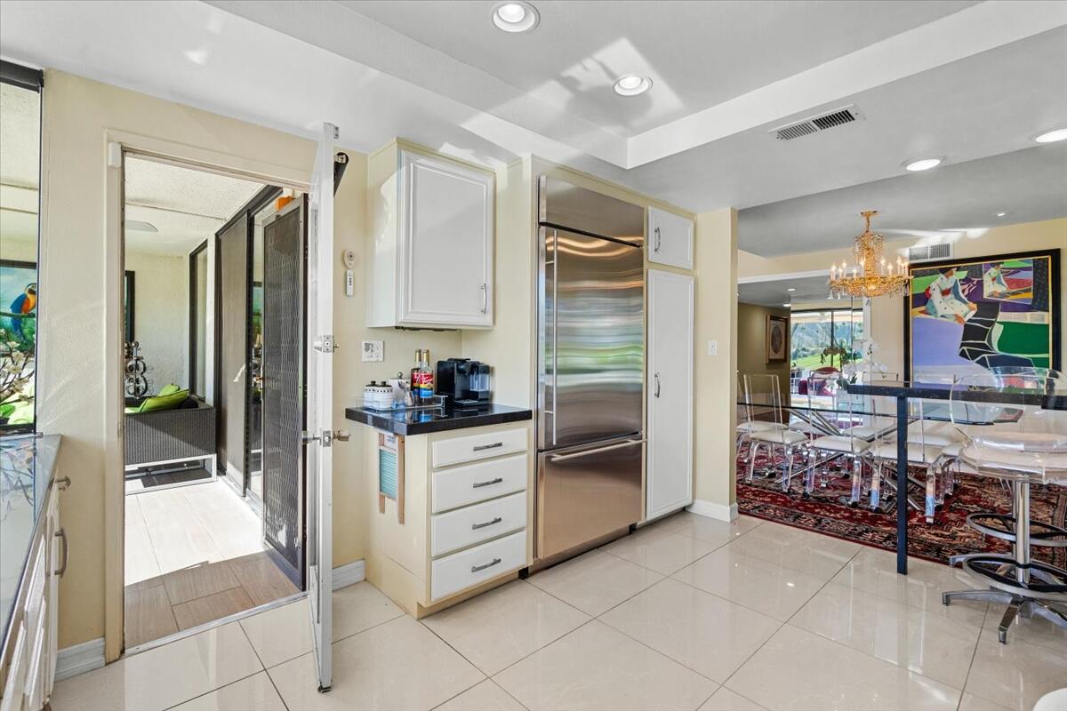 1 Cueta Drive Rancho Mirage, CA 92270 - Photo 12 of 39 a kitchen with stainless steel appliances kitchen island granite countertop a refrigerator and a sink