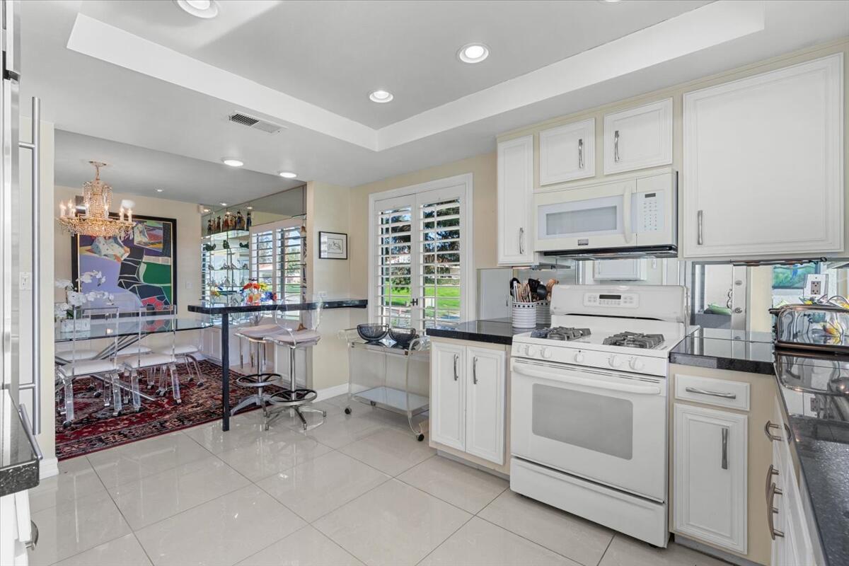 1 Cueta Drive Rancho Mirage, CA 92270 - Photo 14 of 39 a kitchen that has a lot of cabinets in it and appliances