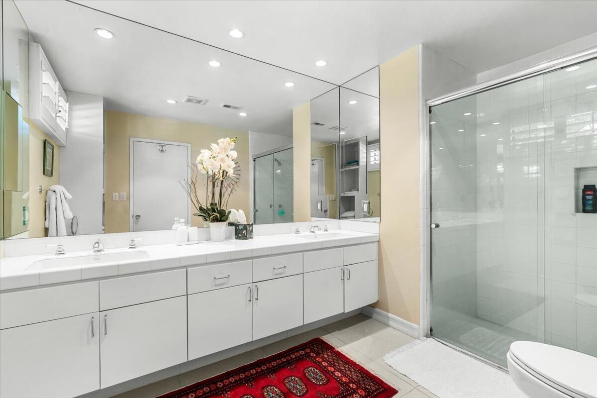 1 Cueta Drive Rancho Mirage, CA 92270 - Photo 19 of 39 a spacious bathroom with double vanity sinks a shower and a mirror