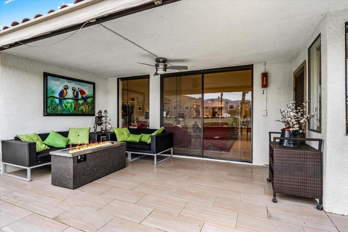 1 Cueta Drive Rancho Mirage, CA 92270 - Photo 23 of 39 a living room with furniture a flat screen tv and a floor to ceiling window