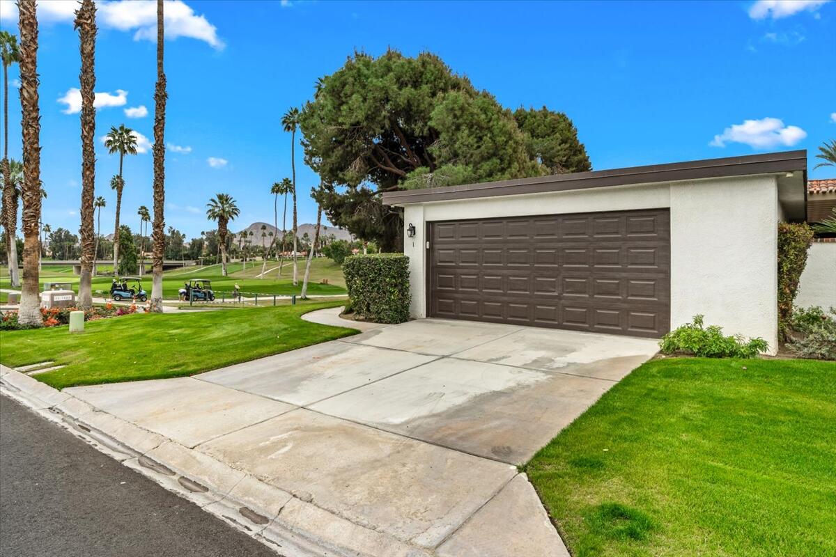 1 Cueta Drive Rancho Mirage, CA 92270 - Photo 36 of 39 a front view of a house with a yard and garage