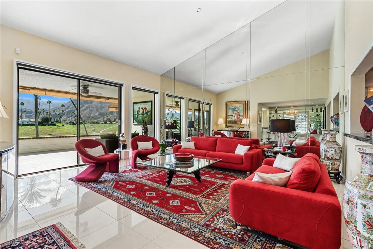 1 Cueta Drive Rancho Mirage, CA 92270 - Photo 4 of 39 a living room with furniture large windows and a flat screen tv
