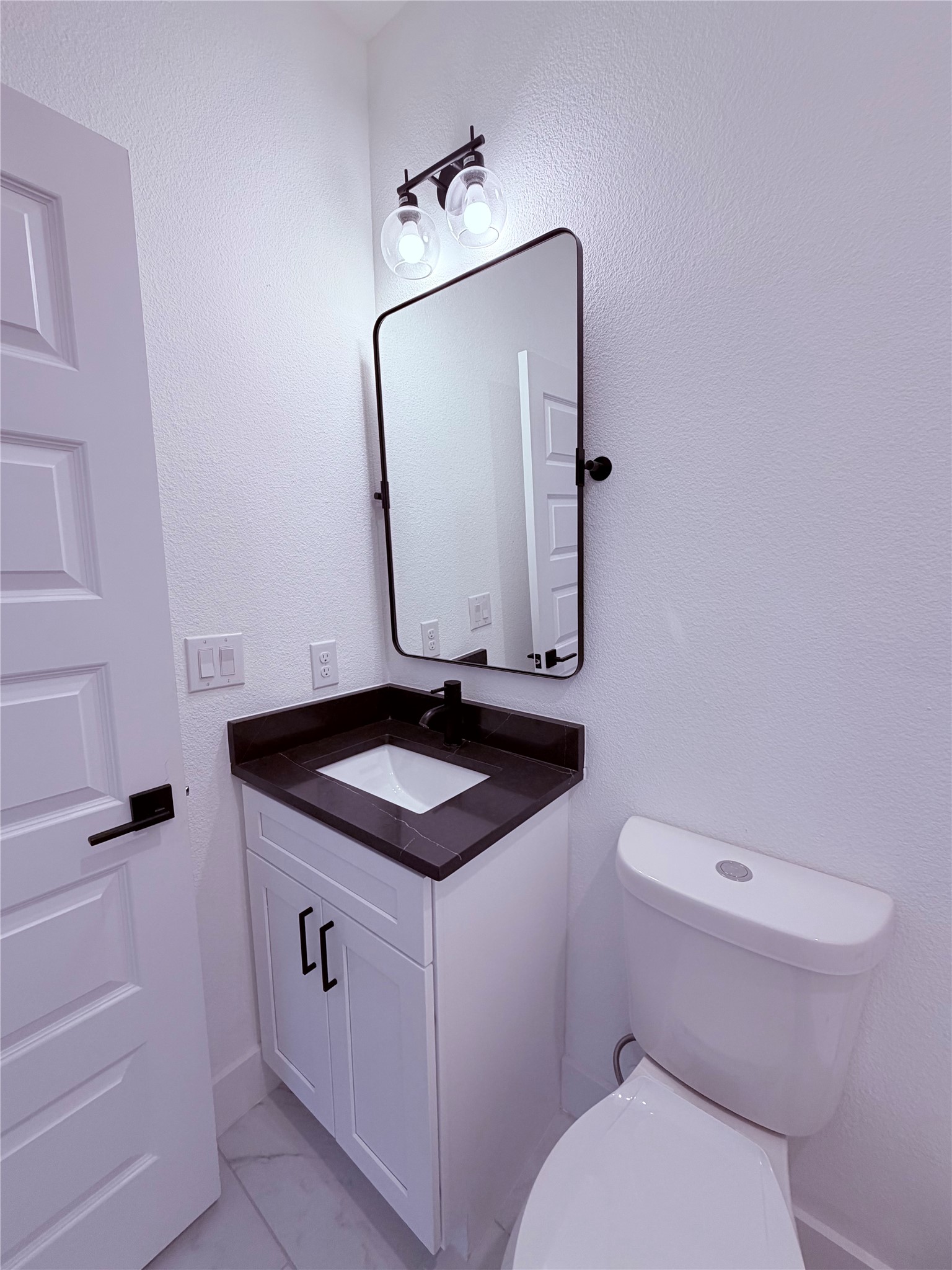 1417 Kramer Lane, Unit 7 Austin, TX 78758 - Photo 4 of 24 A well-appointed lavatory with a modern vanity and clean lines.