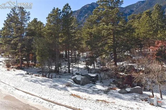 a view of a dry yard with mountains in the background